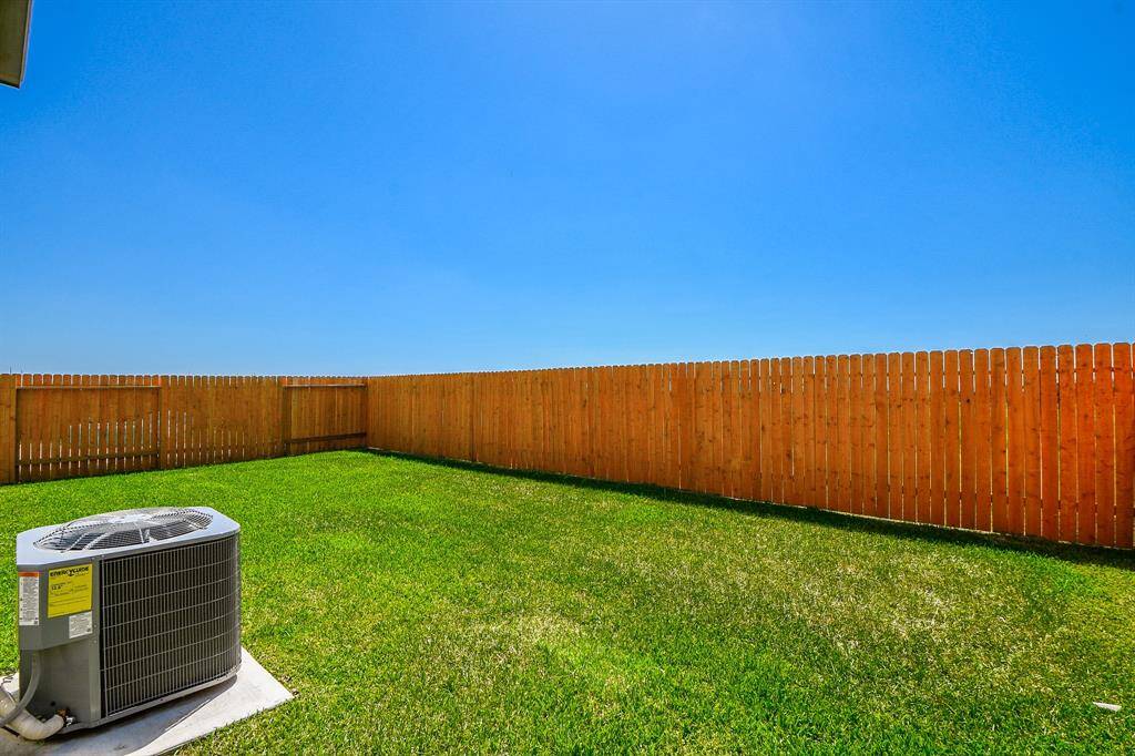 Look at this gorgeous green lawn and fully fenced backyard.