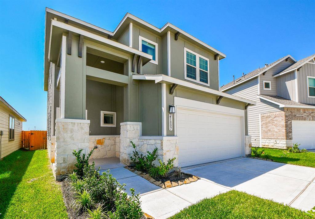 The spacious two-car garage and long driveway offers ample parking.
