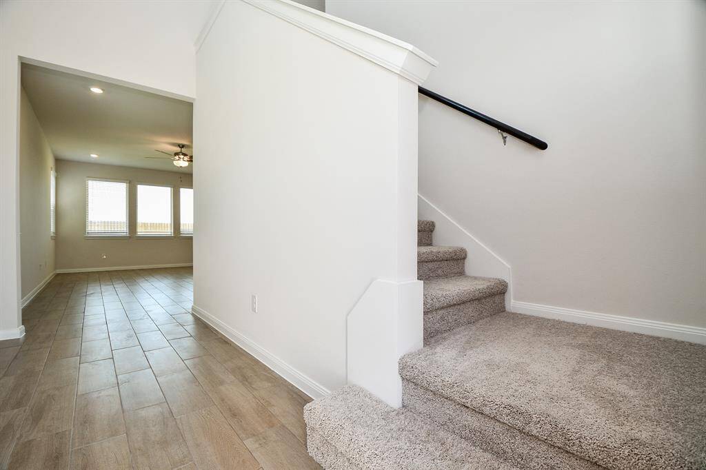 The plush carpeted steps ascending to the upper level.