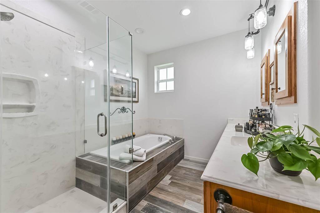 The primary bathroom features double sinks, walk-in shower and a soaking tub