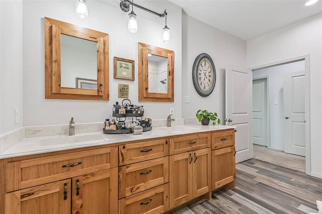 The primary bathroom features double sinks, walk-in shower and a soaking tub