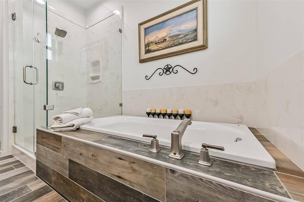 The primary bathroom features double sinks, walk-in shower and a soaking tub