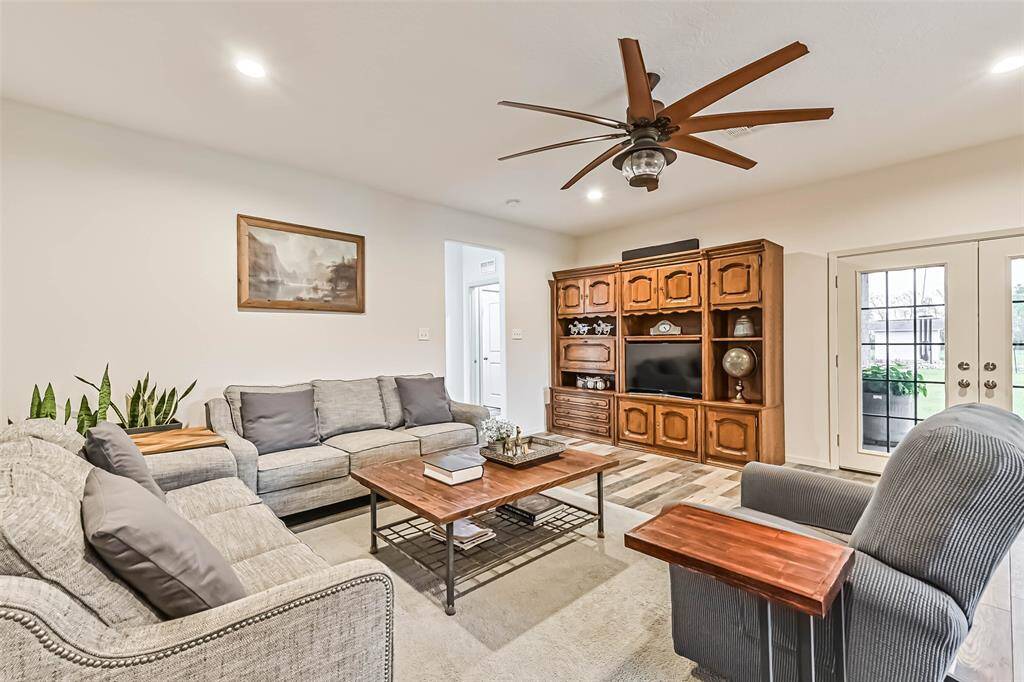 The living room has French doors that open to a back covered patio