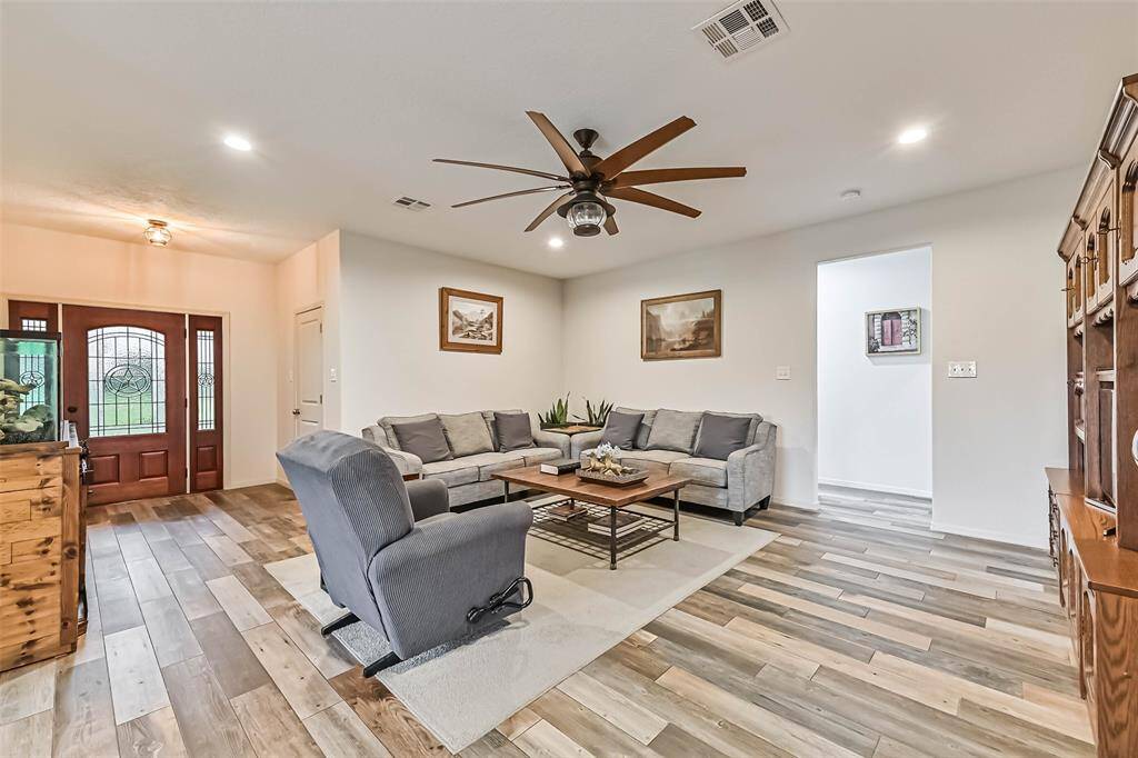 The living room has French doors that open to a back covered patio