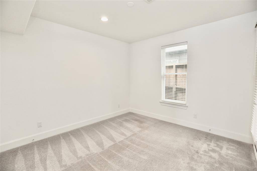 3rd bedroom 1st floor; includes closet, full bath and back door to access to the turfed backyard