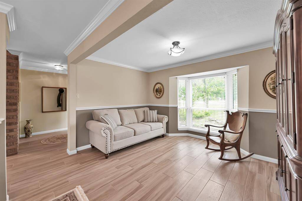 Formal living area could double as an office with a nice view out the bay window.