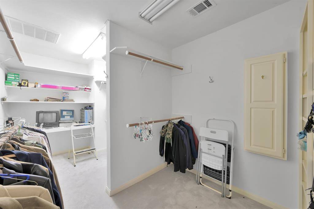 Walk in primary closet with room for all your clothes and more.