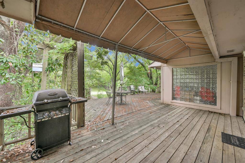 Back deck can be accessed from the kitchen, den and primary bedroom.