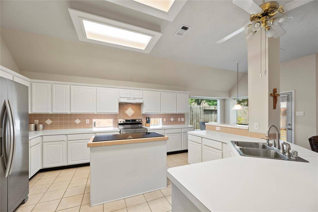 Your chef inspired kitchen awaits! Features include easy care countertops paired with a coordinating tile backsplash, stainless steel appliances, crisp white cabinets, new LED ceiling lights, and a sprawling island with breakfast bar seating.