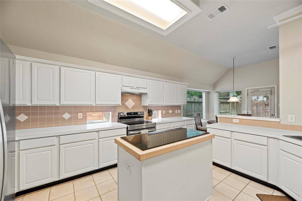 Crisp white cabinets provide a clean and timeless look, enhancing the sense of brightness and openness in this space.