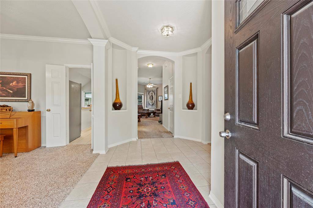The charming brick exterior and inviting pathway leading to the front door create exceptional curb appeal.