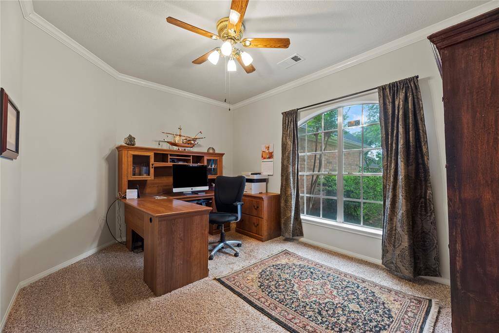 To the left of the entry, you'll find a stylish formal living area, perfect for entertaining guests or creating a cozy gathering space.