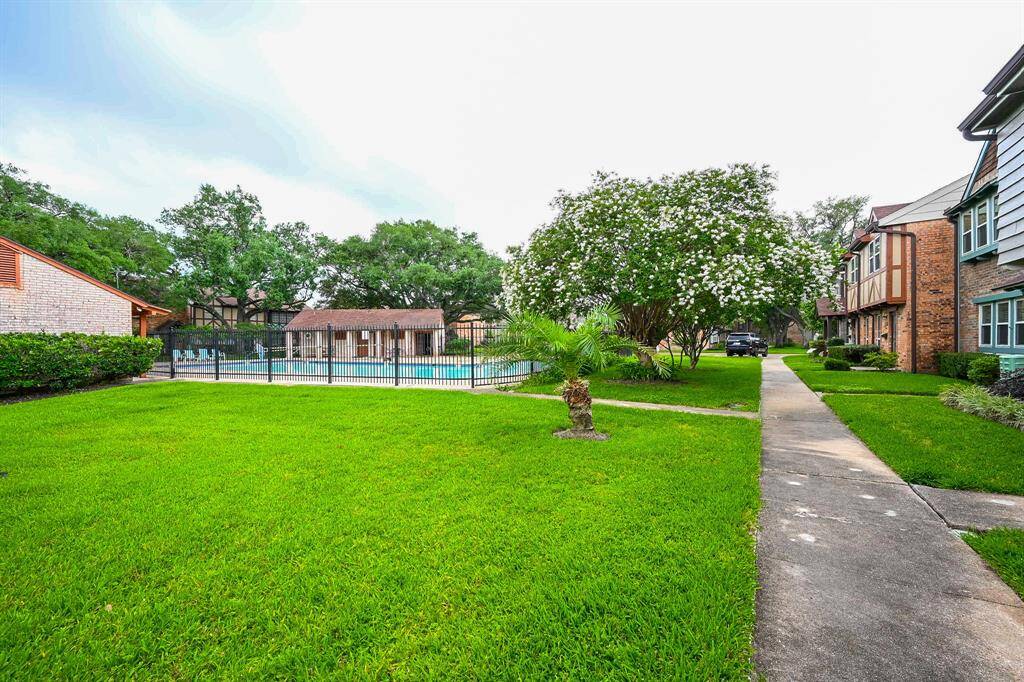 Enjoy a refreshing swim in the inviting community pool, surrounded by lush greenery and a well-maintained landscape. Perfect for relaxation and social gatherings.