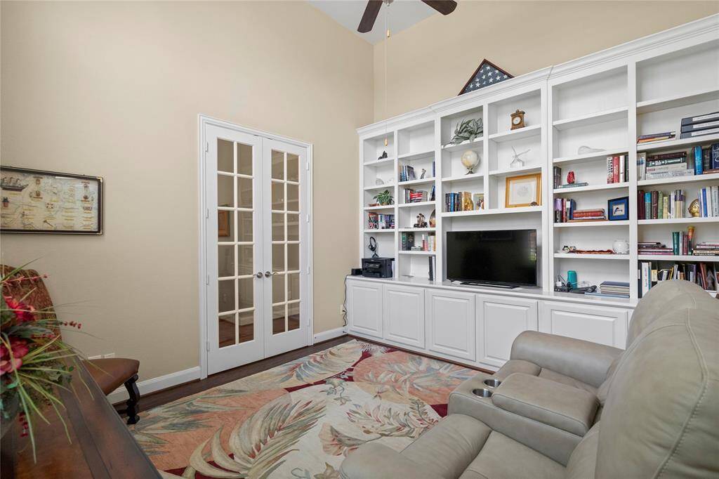 Elegant study featuring spacious built-in shelving for organized storage and display.
