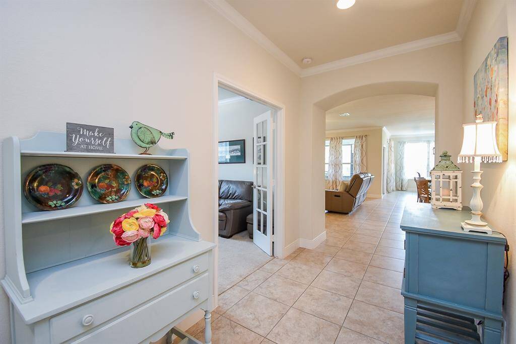 Another view of the entryway leads into the spacious family room. Before moving forward, to your right, you'll find the laundry room, an additional storage closet, and the door leading to the attached oversized garage.