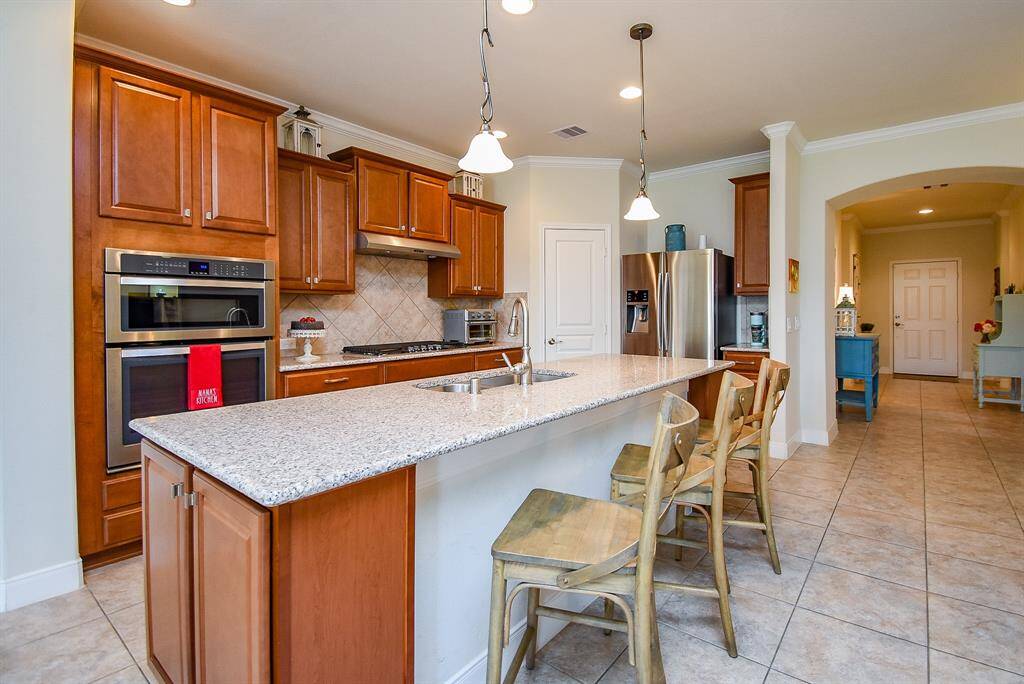 Take a look at the extra storage space thoughtfully added at the end of the island—perfect for keeping essentials within reach. With its generous layout, this kitchen offers plenty of room for hosting and entertaining with ease.