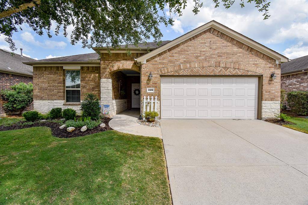 Modern all-brick and stone home with impressive curb appeal, featuring a spacious private porch, a stylish entryway, and a beautifully maintained yard with a full-home sprinkler system—perfect for effortless outdoor living and entertaining.