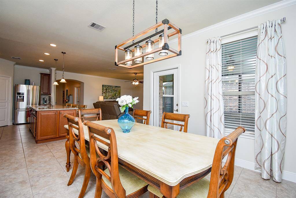The formal dining room is light and bright with upgraded lighting.  Plenty of room here for that large dining room table and hutch.