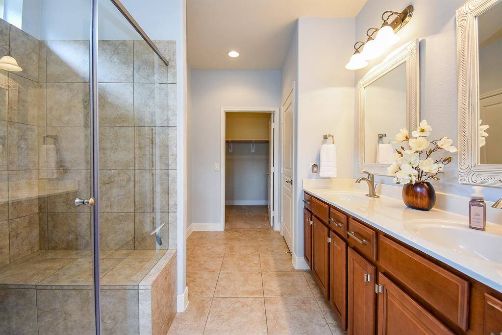 Step into the amazing primary bathroom, featuring an oversized shower with a built-in bench and a window above that brings in natural light. The countertops have been updated with sleek granite, and the space boasts upgraded fixtures, mirrors, and cabinet pulls—every detail has been carefully considered to elevate the space.