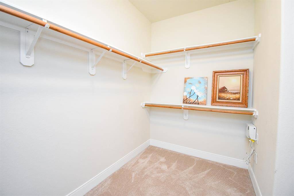 spacious primary closet—there’s plenty of additional room on the other side, offering ample storage for clothing, shoes, and accessories.
