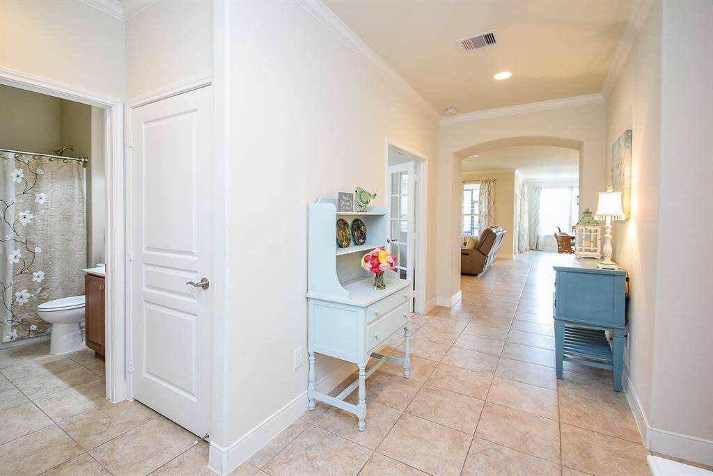 From this view, you’ll notice the full bathroom along with an additional storage closet for convenience. Just to your left, the dedicated office features French doors, offering both style and privacy—perfect for working from home or quiet study.