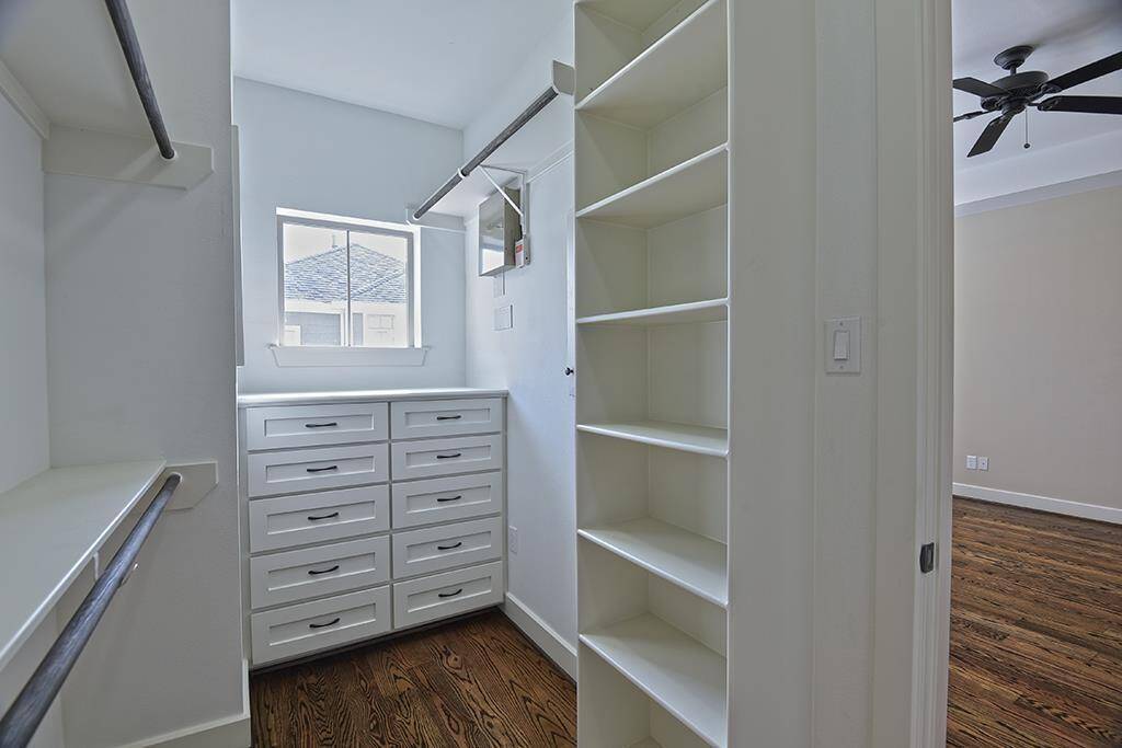 Walk-in closet in primary offers custom built-ins!