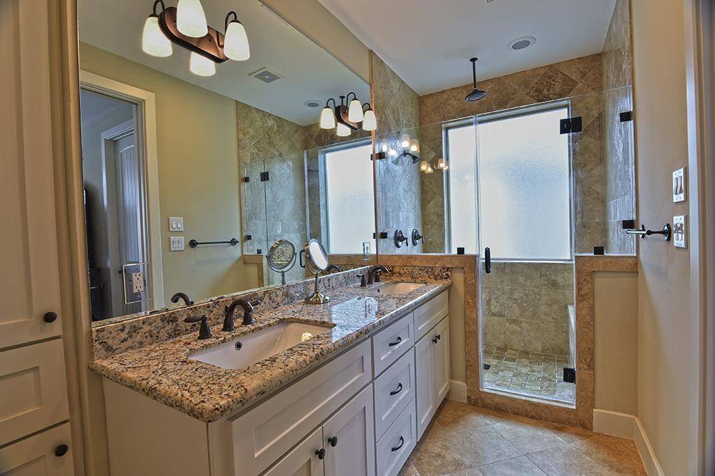 Primary bath has dual sinks and a large custom shower