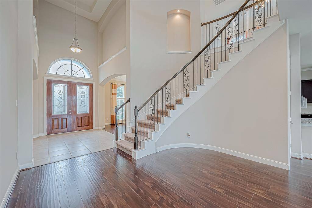 The beautiful curved staircase leads to the upstairs area.