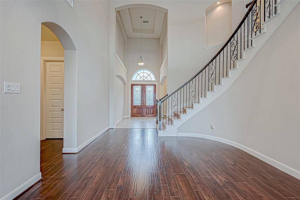 The beautiful curved staircase leads to the upstairs area.
