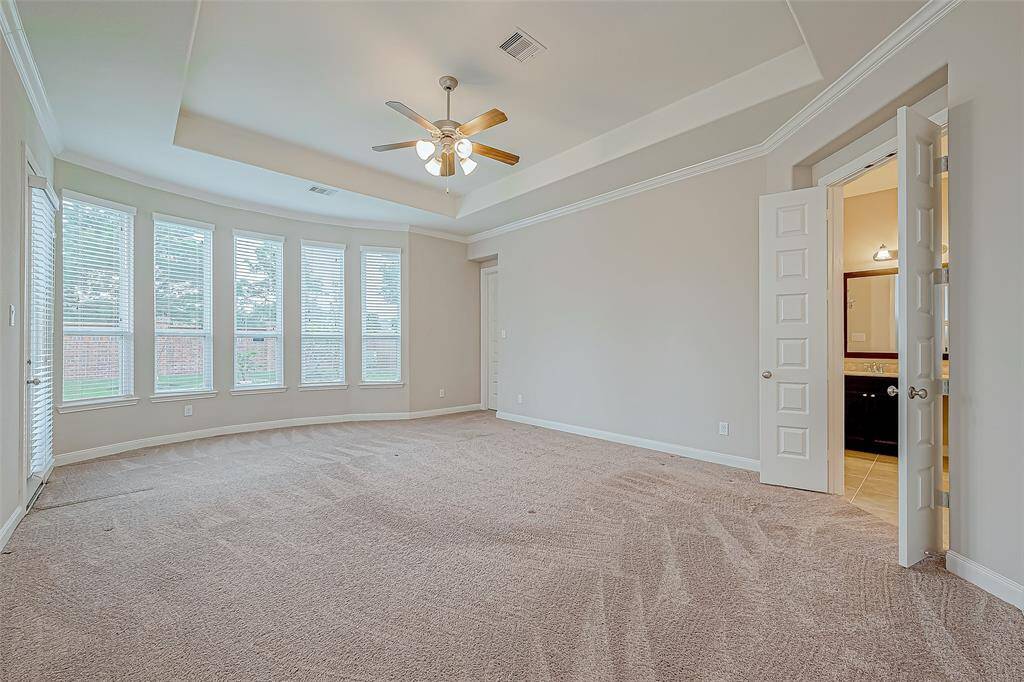 The master bedroom is a spacious and tranquil retreat, featuring large windows that let in plenty of natural light. With plenty of room for a king-sized bed and additional furniture, it offers a peaceful escape with a relaxing atmosphere.