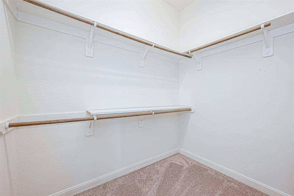 The master closet is incredibly spacious, providing plenty of room for organization and storage. It offers ample hanging space and shelving, making it easy to keep your wardrobe neatly arranged.