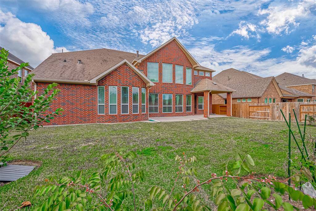 The large, spacious backyard offers plenty of room for outdoor activities, gardening, or entertaining. It provides a perfect setting for family gatherings and enjoying the outdoors.