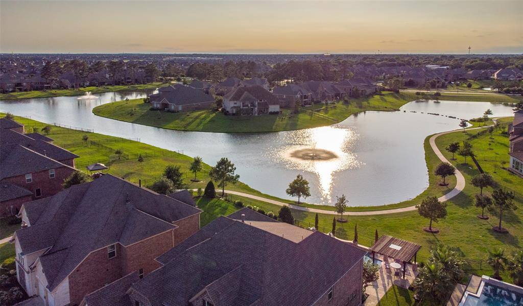 The aerial view highlights a spacious backyard with peaceful lake views, creating a relaxing and scenic space for outdoor activities.