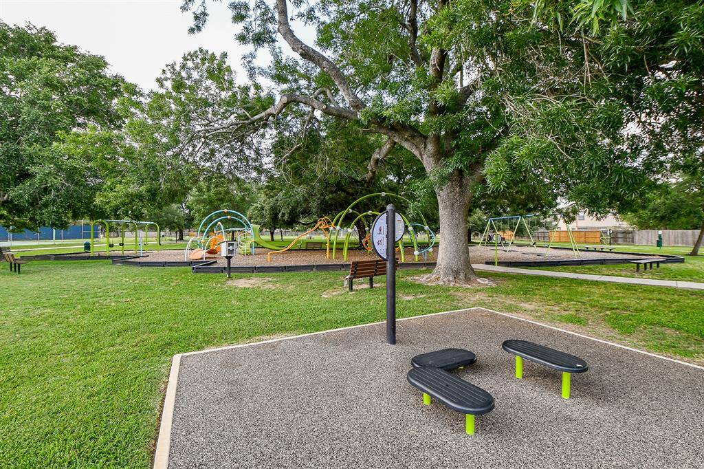Well-maintained park with a variety of playground equipment and exercise set amidst lush greenery, providing a welcoming and family-friendly outdoor space.