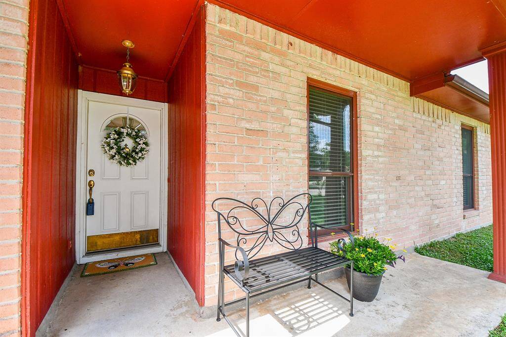 A welcoming front porch with a brick exterior and upgraded extended porch. The space is inviting and well-maintained.