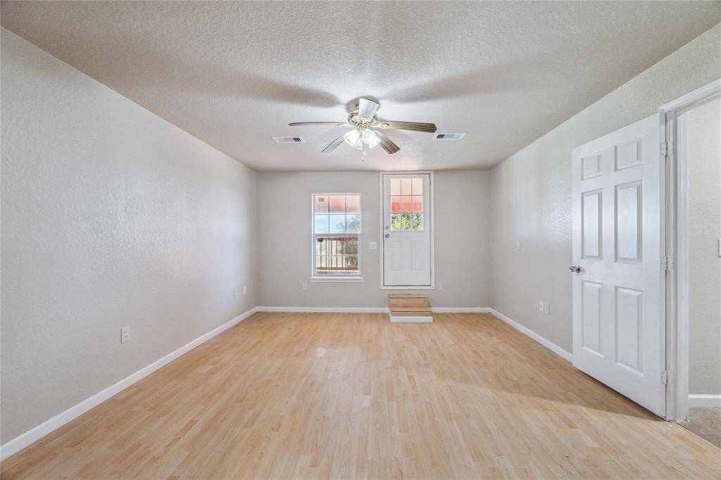 The upstairs primary bedroom includes a private full bath and a tranquil balcony overlooking the spacious backyard.