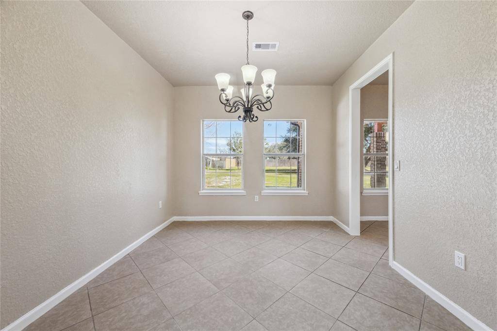 Enjoy unforgettable gatherings in this inviting dining room with expansive backyard views.