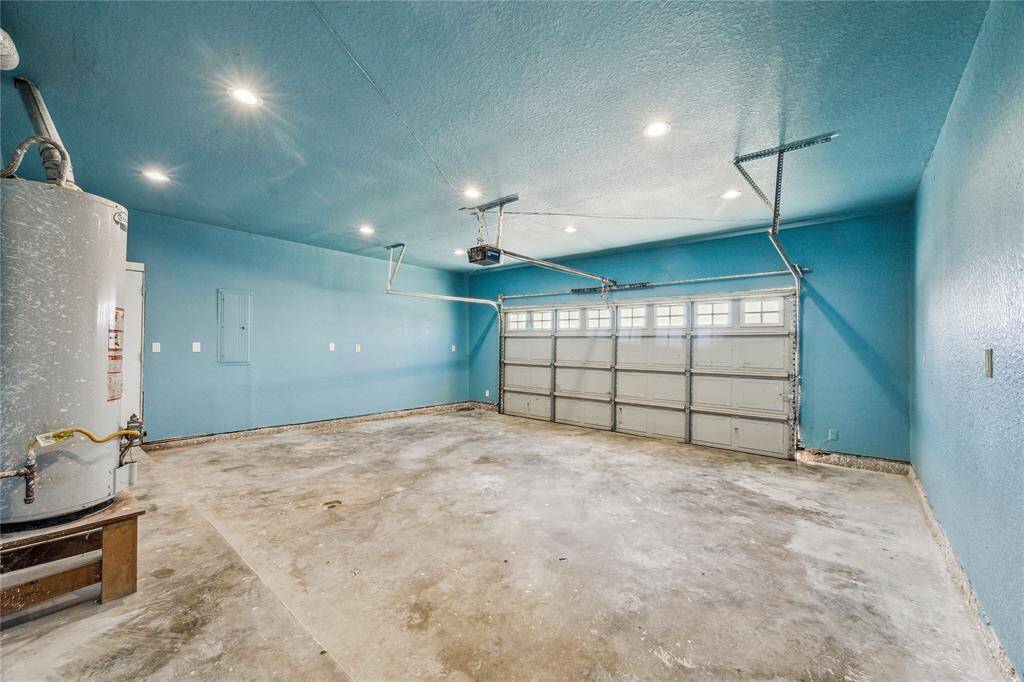 Bright, spacious two-car garage with convenient yard access through a side door.