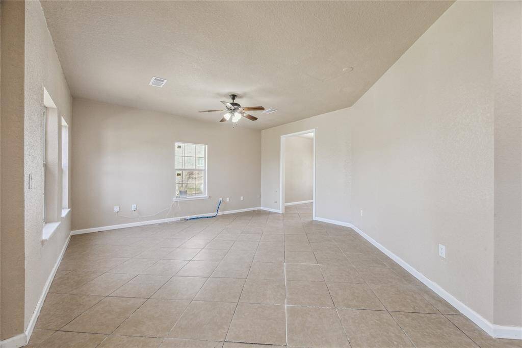 Welcome to this inviting living room, bathed in natural light as you step inside.