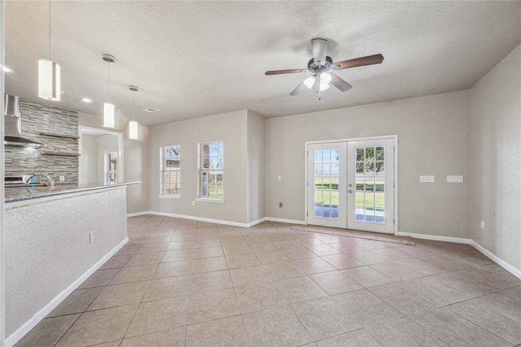 This inviting family room offers seamless flow to the kitchen and opens directly to the back patio.