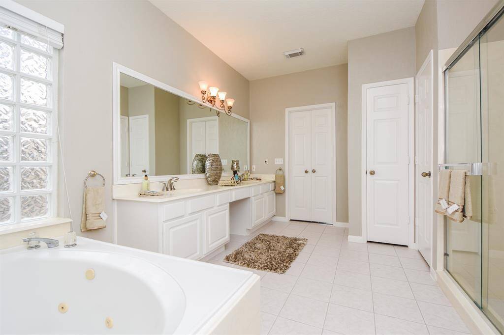 Complete with a private powder room, double sinks, and a jetted tub this bathroom is sure to impress!