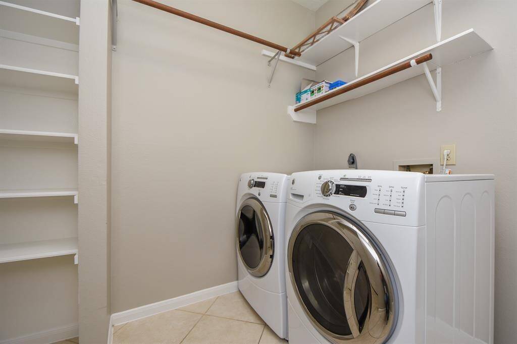 The utility room includes a washer and dryer.