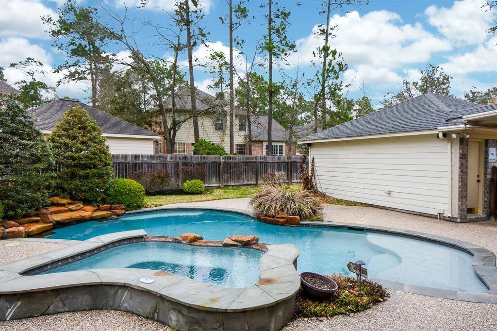 The backyard showcases a large pool and hot tub.
