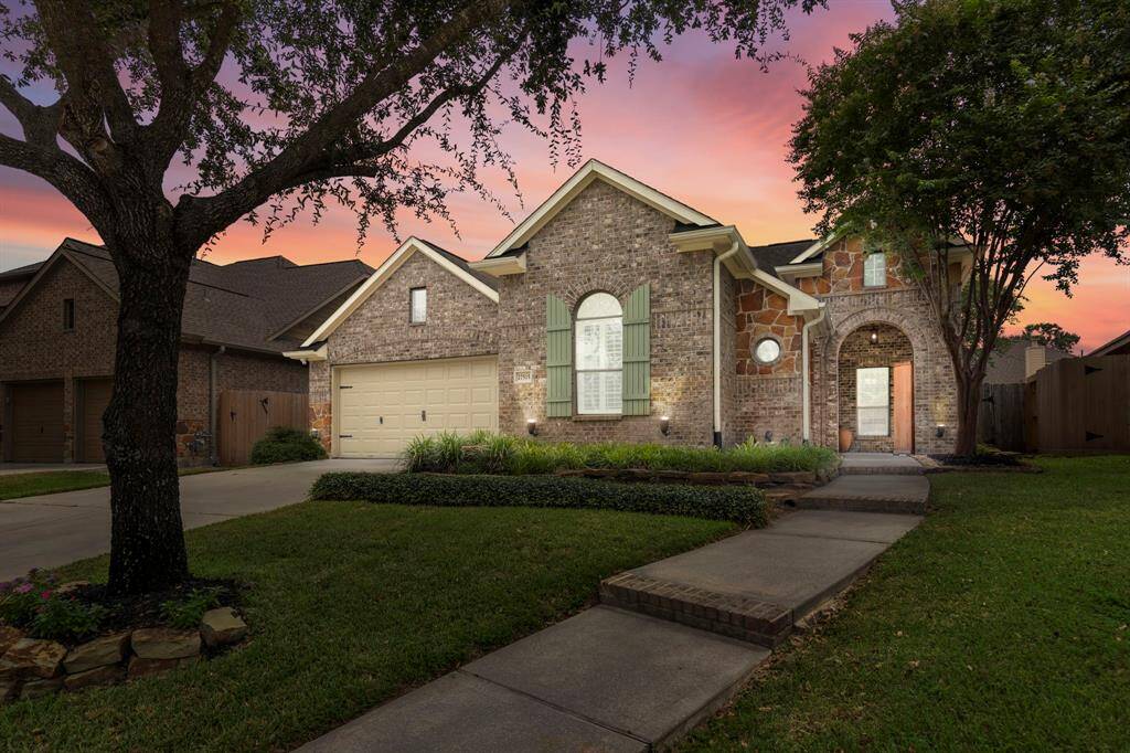 Framed by mature trees and lush landscaping, this beautifully maintained brick and stone exterior home welcomes you with timeless curb appeal on a peaceful cul-de-sac street.
