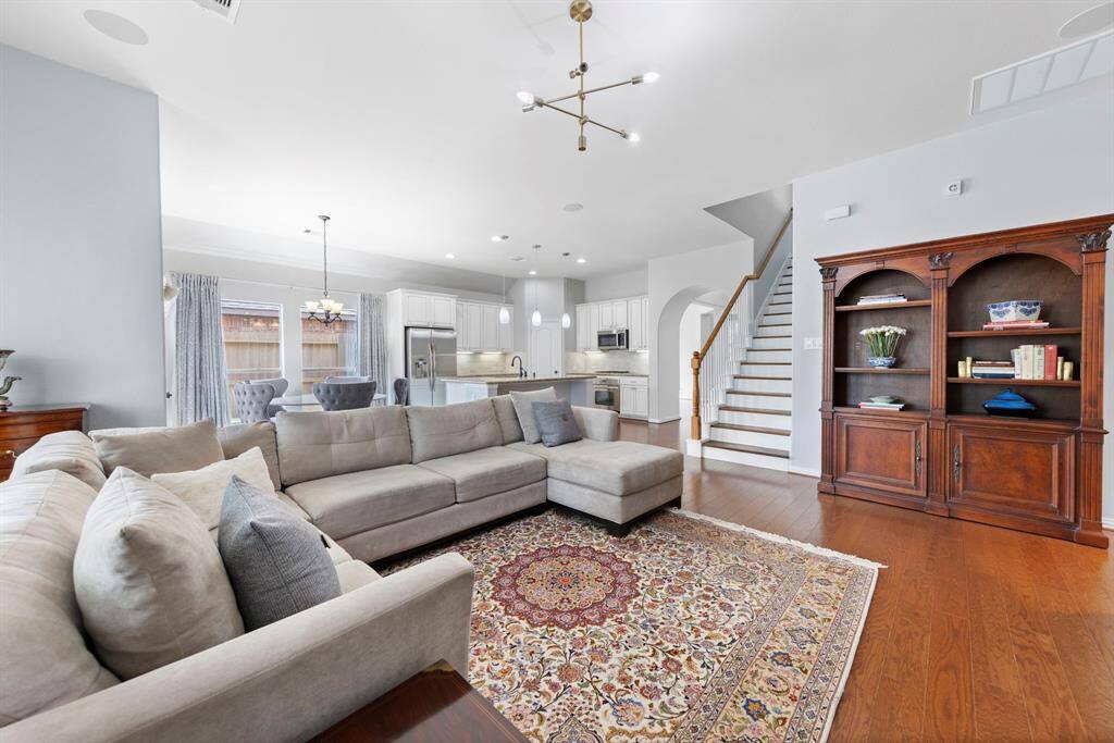 This open-concept layout blends kitchen, dining, and living areas for easy, connected living in a clean, neutral setting.