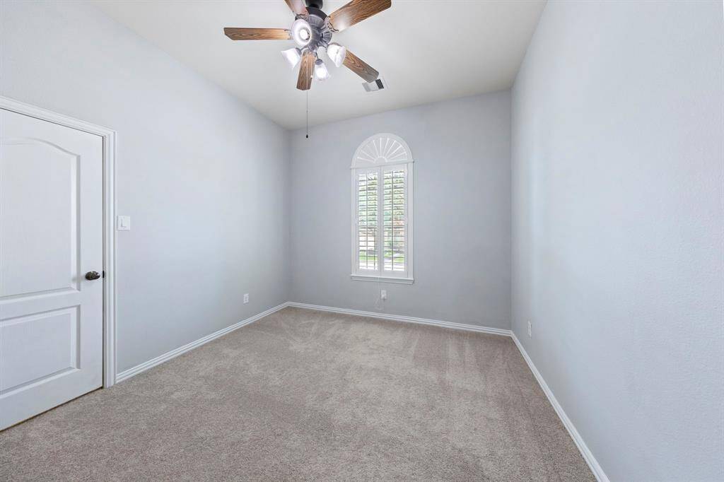 Two secondary bedrooms feature neutral tones, plush carpeting, closets and windows—perfect as bedrooms, home offices, or flex spaces.