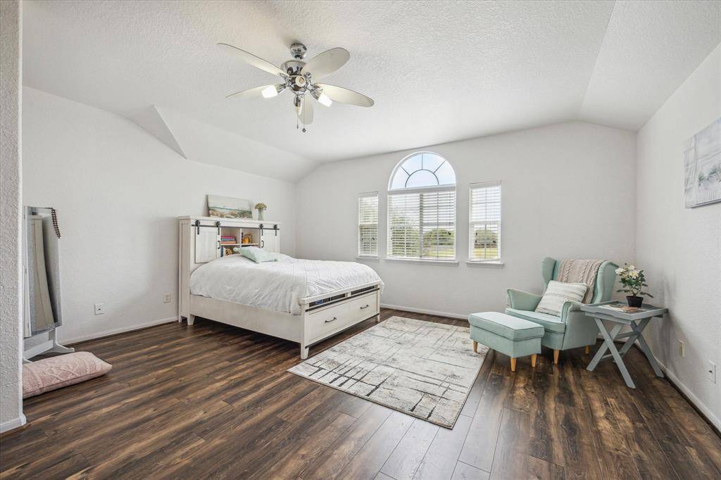 UPSTAIRS PRIMARY BEDROOM WITH SERENE VIEWS OF THE WALKING PARK ACROSS THE STREET