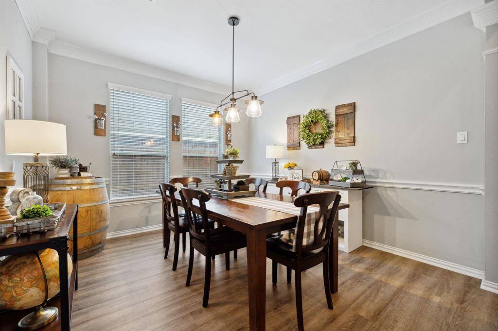 Formal dining room with lovely crown molding, easy maintenance flooring throughout this home,
