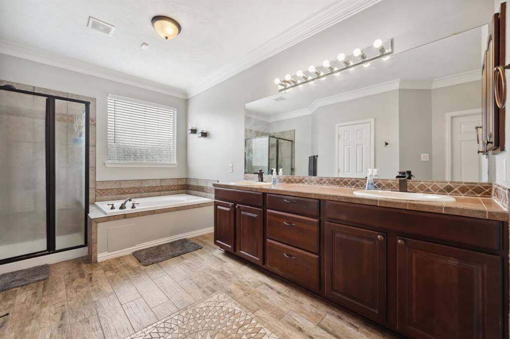 Primary bath with double sinks, jetted tub, separate shower, great cabinet space.
