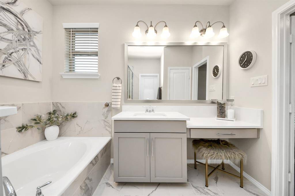 Primary bathroom, framed mirror to be replaced with unframed mirror above sink (not pictured).